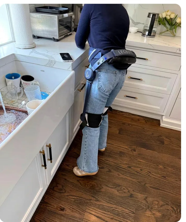 Person standing in their kitchen while wearing Legbots Assist